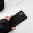Model holding 3D Plaid Phone Case in black. Sleek urban style accessory, perfect for professional office chic.
