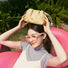 Model holding a cream yellow bag over her head, easy for commuting and weekends.