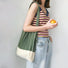 Model carrying a forest green Accordion Foldable Knitted Bag on shoulder , great for daily carry and travel.