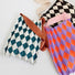 Comparison of three color variants of the stretchable argyle pleated bag.