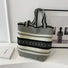 Front view of the artistic pattern bucket bag with bold black and white stripes and geometric details.
