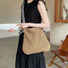 Model styling the striped straw bag with crossbody strap as a casual summer carry.