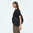 Side view of the black puffy nylon bag, highlighting its extra-roomy capacity and soft texture.
