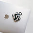 Flat lay of Black Wave Airpods Case Cover, great for daily protection and travel.