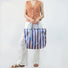 Model carrying a violet Bold Color Striped Tote Bag handheld, great for daily carry and travel.