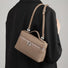 Model carrying a khaki shoulder bag , ideal for city walks and gifting.