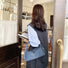 Model carrying a dark blue Braided Handle Denim Handbag, easy for commuting and weekends.