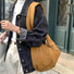 Camel brown padded bag paired with a denim jacket, showcasing a relaxed urban casual style.