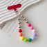 Angled view of Candy Bead Phone Charm in rainbow colors, easy to attach to bags and phones.