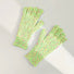 Green candy-dot knit gloves with raised dot texture and ribbed cuffs; playful warmth for everyday wear.