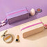 Top and side view of purple and khaki silicone cosmetic pouches displaying the smooth zip-top fastening.
