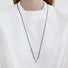 Model wearing silver Celestial Drop Pendant Necklace in Silver, minimalist elegant jewelry style.