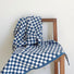 Flat lay of blue checkerboard bath towel on a chair.