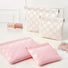 Pink and white checkered self-closing bags in multiple sizes; woven checker pouches for travel and cosmetics.