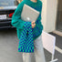 Model styling the blue and green checkered woven tote bag with a casual outfit.