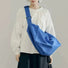 Model carrying a blue Chic Day Hobo Bag as crossbody, great for daily carry and travel.
