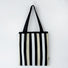 Front view of Chromatic Stripe Knitted Bag in black and white, ideal for errands and gifting.