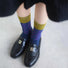 Model wearing a pair of navy blue cotton socks, easy for travel days and daily comfort.