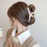 Model wearing Colored Yarn Hair Claw in beige, ideal for quick updos and ponytails.