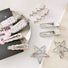 Front view of Silver alloy hair clips with colorful polka dots in various shapes: wave, arrow, and star.