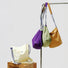 Multiple waterproof nylon bags hanging, highlighting the lightweight and foldable design for travel and daily life.