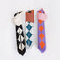 Demonstrating the foldable storage feature of the argyle knit bag, rolled into a compact size.