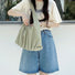 Model wearing the green pleated shoulder bag; showcases the lightweight nylon texture and effortless urban style.