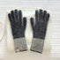 Black contrast striped knit gloves with ribbed cuff and bold banding; classic winter glove style.