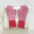Flat lay contrast striped knit gloves in red and white with ribbed cuffs, styled on a sweater; cozy winter wear.