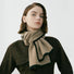 Model wearing a beige wool-polyester knit scarf with black contrast trim, tied around the neck in gray, great.