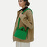 Vibrant green padded bag styled as a shoulder bag, highlighting the soft lightweight material and knotted handle.