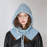 A model wearing a cool blue drawstring buttoned balaclava hat, showcasing the knit texture and bow tie detail.
