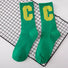 Flat lay of Cool C Socks in green, great for daily wear and lounging.