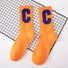 Flat lay of Cool C Socks in orange, easy to pack for travel and errands.