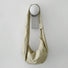 Khaki corduroy crescent bag hanging on a minimalist wall hook.