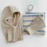 Front view of beige ribbed knit balaclava hat. Elegant neutral tone for sophisticated winter layering.