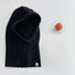 Front view of black ribbed knit balaclava hat. Sleek minimalist aesthetic for versatile cold-weather gear.