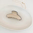 Angled view of Cream Black Border Hair Claw in curve shape, ideal for quick updos and ponytails.