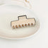 Angled view of Cream Black Border Hair Claw in rectangle shape, great for everyday styling and gifting.