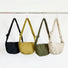 Display of the quilted crescent crossbody bags in four colors, including black, yellow, olive green and white.