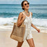 Model wearing khaki crochet straw tote bag on shoulder, clean coastal aesthetic.