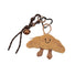 Fluffy brown polyester croissant bag charm with a smiling face, small feet, and a dark brown rope with a bell.