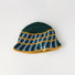 Detailed top view of the green bucket hat, with yellow and light blue cross striped pattern.