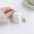 Model holding a Crystal Shell AirPods Case Cover, great for daily protection and travel.