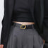 Model wearing the black belt with a curved oval gold buckle, versatile matching for casual outfits