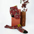 Front view of red Dancing Flower Socks with green leaf pattern and olive green cuffs.