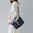 Model carrying a Denim Trimmed Messenger Bag on her shoulder, ideal for city walks and gifting.