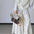 Model carrying a Denim Trimmed Messenger Bag handheld, great for daily carry and travel.
