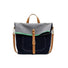 Front view of Denim trimmed messenger bag with gray flap, brown straps, magnetic closure, and green accent.