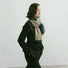 Model wearing a striped scarf Designer Soft Striped Scarf in green, easy for weekend styling and gifting.